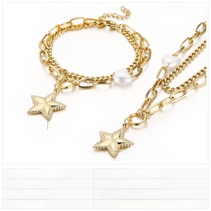 Detail view of gold stainless steel necklace and bracelet set with shell heart charms
