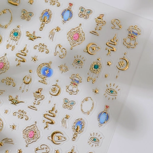 3D metallic gold nail art stickers with celestial and exotic lamp designs on grey background