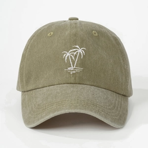 Close-up of white palm tree embroidery on a washed cotton olive green baseball cap
