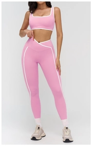 Detail of pink yoga set featuring white contrast binding and V-shaped crossover waistband