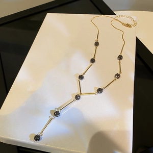 Luxurious gold Y-shaped sweater necklace with elegant black crystal balls and long chain