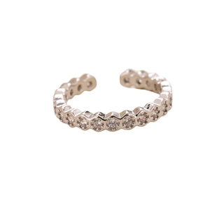 Adjustable silver ring featuring single row of cubic zirconia in hexagonal settings