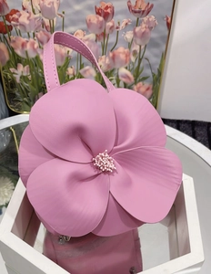 Detail of pink 3D flower tote bag with textured petals and delicate floral stamen core