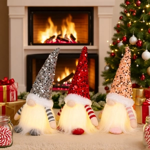 Three glowing Christmas gnomes with colorful sequin hats and warm LED lights