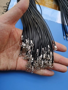 Detailed macro view of black braided necklace cords with durable silver metal clasps