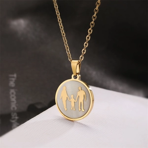 Macro detail of golden titanium steel family necklace featuring parent and child silhouettes