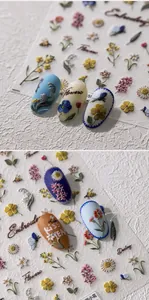 Detailed view of 5D embossed floral nail stickers with textured flower and bee designs