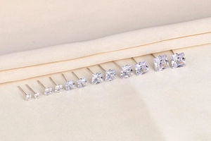 Macro view of square S925 silver stud earrings with zirconia in various sizes