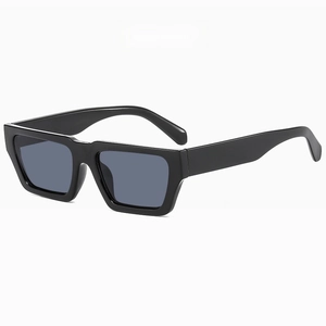 Detail of modern rectangular sunglasses featuring glossy black frames and full grey lenses