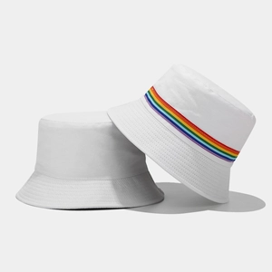 Close-up of white cotton bucket hat with vibrant rainbow stripe detail and soft texture