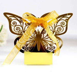 Intricate laser-cut gold butterfly gift box with detailed wing patterns and yellow ribbon