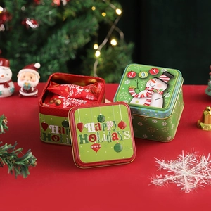 Christmas square tin box with snowman pattern and lid open showing candies inside