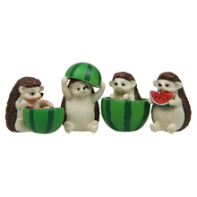 Detailed view of four resin figurines featuring hedgehogs with watermelon miniatures