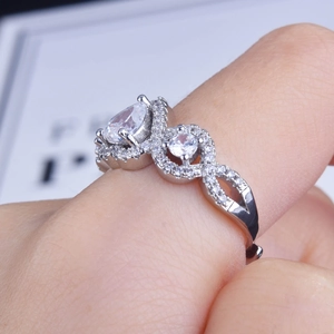 Macro detail of silver ring with drop-shaped and round crystal stones on a twisted band
