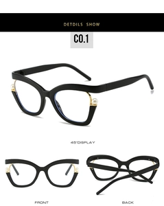 Detail view of cat eye black frames featuring white pearl hinges and gold metal accents