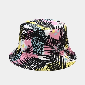 Close-up of bucket hat showing palm leaf silhouettes and leopard spots on canvas