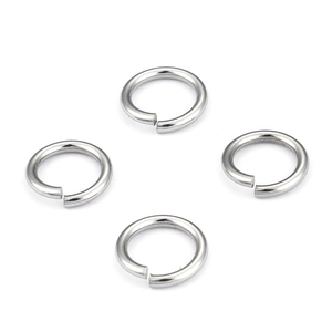 Detailed view of four polished stainless steel open jump rings for DIY jewelry making