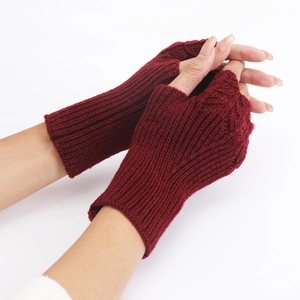 Close-up of deep red knitted fingerless gloves with texture on a white background