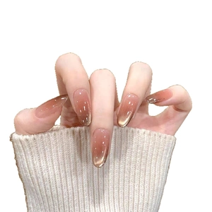 Faux ongles œil de chat ovales longs avec dégradé pailleté ambre et fini brillant