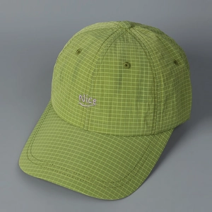 Close-up of green checkered baseball cap with purple Nice embroidery and breathable texture