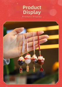 Detail of four ceramic lucky cat charms with natural gemstone beads and woven cords