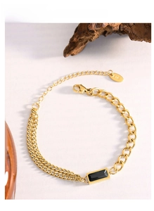 Detail of 18K gold-plated double-layer chain bracelet with a rectangular black gemstone