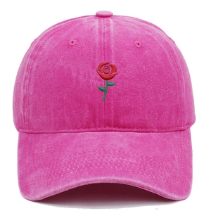 Close-up of red rose embroidery on pink washed cotton vintage baseball cap detail