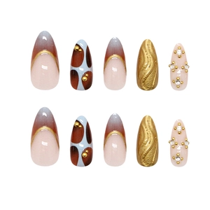 Handmade almond press-on nails with 3D gold accents, cow print, and luxury crystal rhinestones