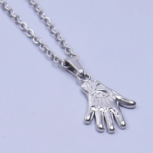 Detailed view of silver Hamsa Hand pendant with eye symbol on stainless steel necklace