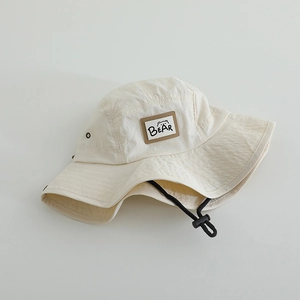 Kids quick-dry beige bucket hat with bear patch and black chin strap for sun protection