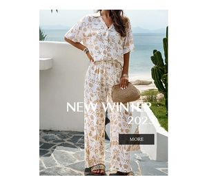 Close-up of tropical palm and geometric print on white summer two-piece shirt and pants