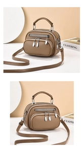 Detail of khaki pebbled leather crossbody bag with three zipper pockets and silver hardware