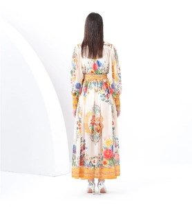 Detail of elegant floral print long dress with back waist cut and voluminous hemline