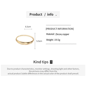 Detail view of 18k gold plated copper bangle with zircon stones and diagonal stripe patterns