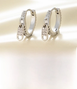 Macro detail of silver zipper head earrings with white cubic zirconia and 10mm diameter