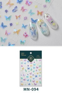 Macro shot of 5D butterfly embossed nail stickers with iridescent star details