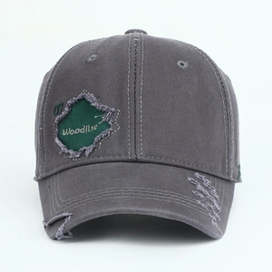 Detail of distressed dark gray cotton baseball cap with maple patch and 07 embroidery