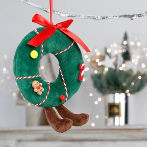 Plush Christmas mushroom wreath ornament with red bow hanging on a festive tree branch