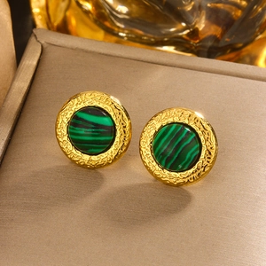 Detail of vintage gold-plated titanium earrings with striped malachite-style stone inlays