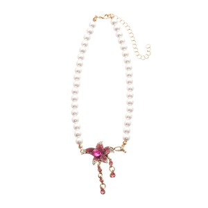 Elegant pearl choker necklace featuring a pink crystal flower pendant and tassel drops