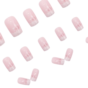 Pink gradient press-on nails with delicate floral patterns and silver glitter accents