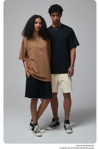 Neutral streetwear lifestyle shot showing oversized cotton t-shirts and shorts in a studio