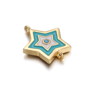 Macro shot of gold-plated star pendant with blue and white enamel inlay jewelry component