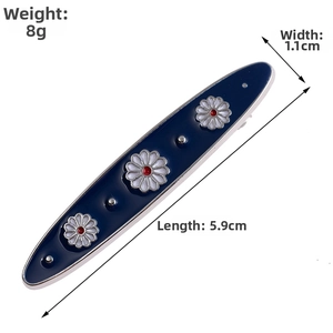 Detail shot of navy blue enamel daisy hair clip with dimensions 5.9cm x 1.1cm and 8g weight