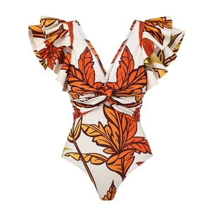 Detail of V-neck one-piece swimsuit with tropical leaf print and ruffled shoulder