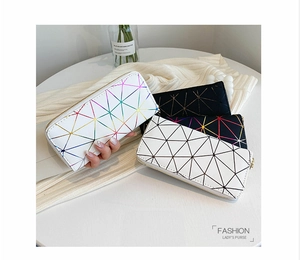 Detailed view of long wallets with geometric triangle patterns on a white surface