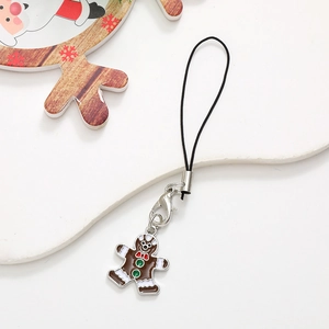 Detailed view of gingerbread man phone charm with brown enamel and red bow decoration