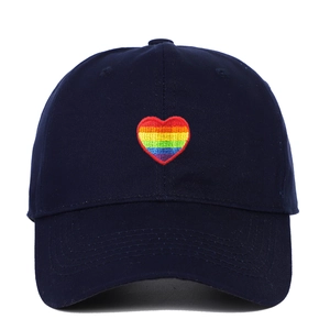 Close-up of rainbow heart embroidery on navy blue cotton twill baseball cap