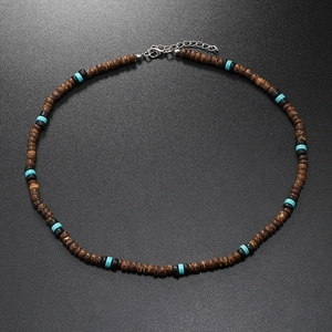 Detail view of surfing necklace with dark brown coconut beads and turquoise stones