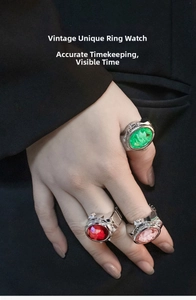 Close-up of vintage flower rings with gemstone watch dials in red, green and pink
